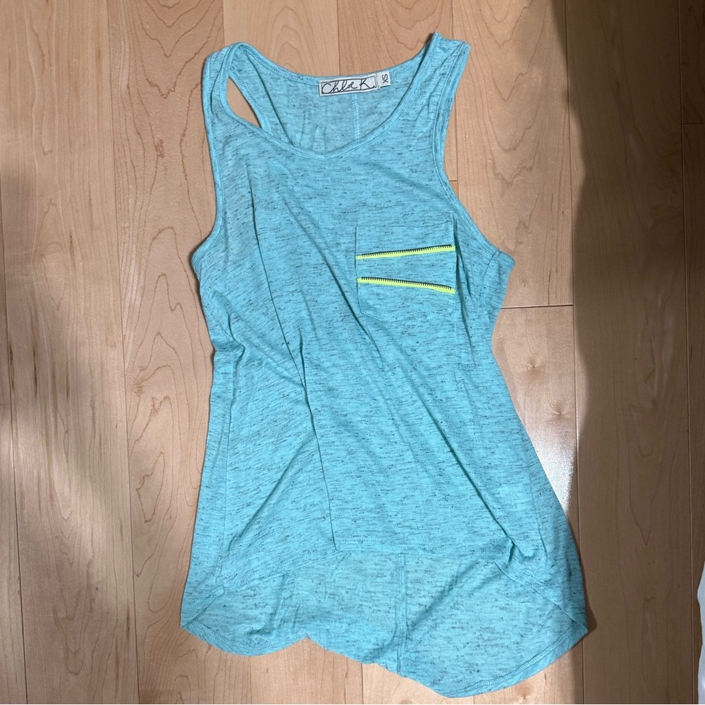 Blue tank top with accent lime green zipper on pocket.